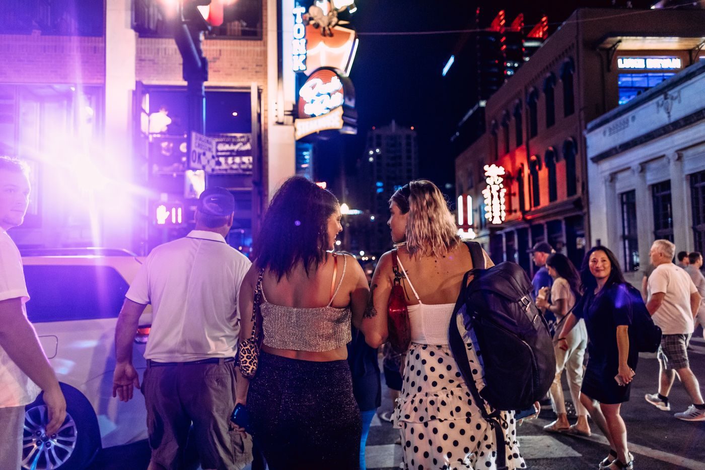 Friends heading out together on a busy nightlife street