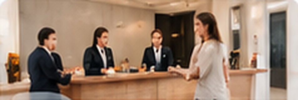 Hotel front desk greeting a guest